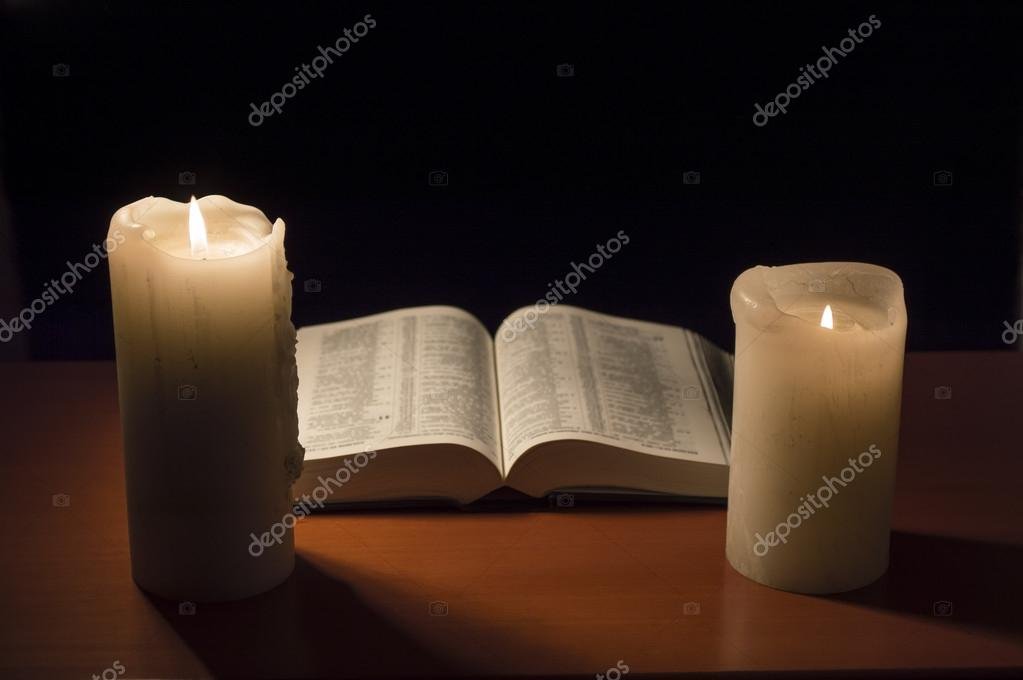 Open Bible and candlelight creating a peaceful prayer atmosphere