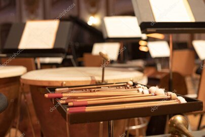 Composer at a studio desk scoring cinematic music on a laptop and keyboard